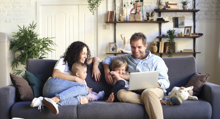 Young beautiful happy family relaxing at home